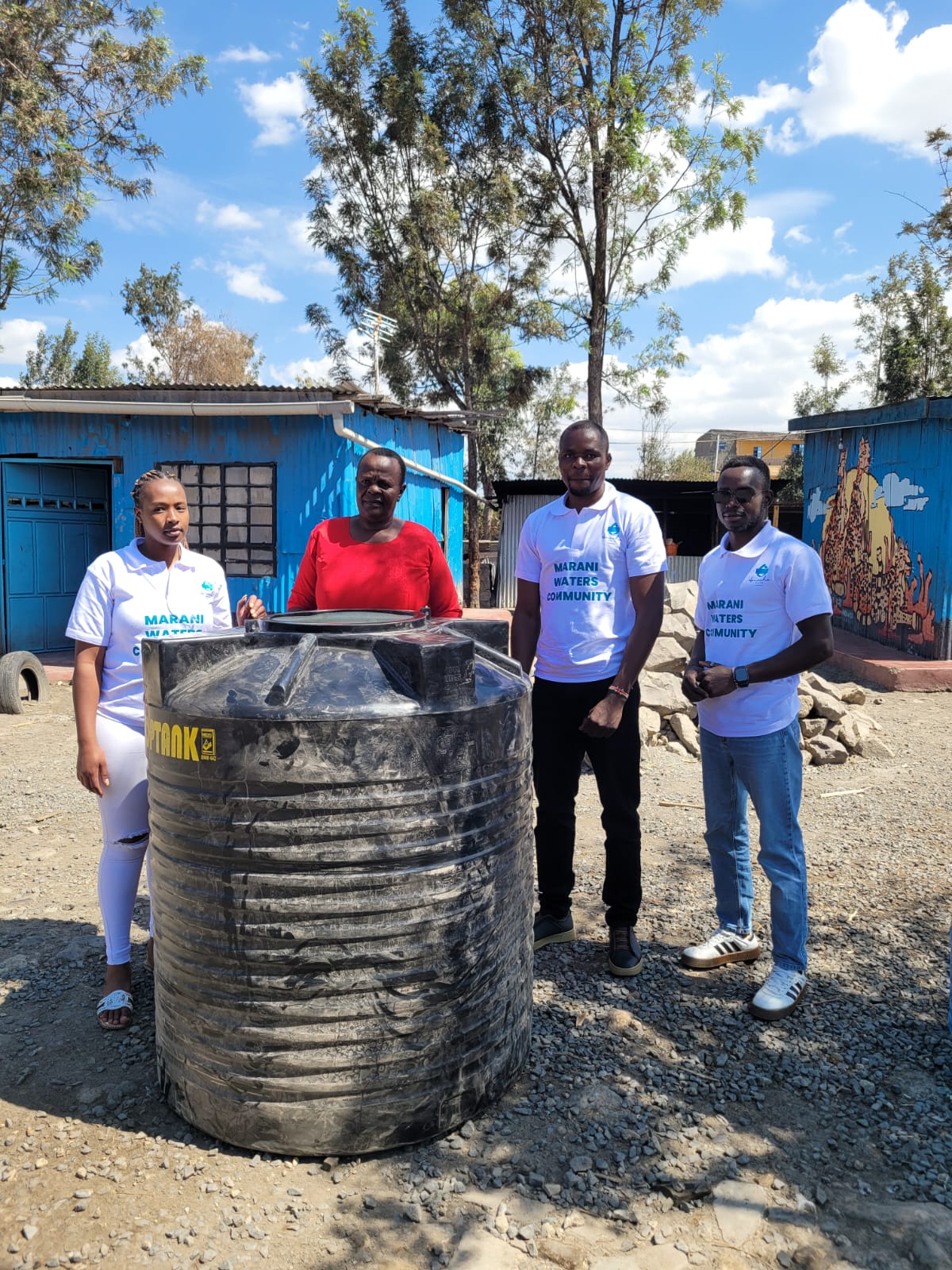 Marani Waters team with a water tank at Neema Mercy Center