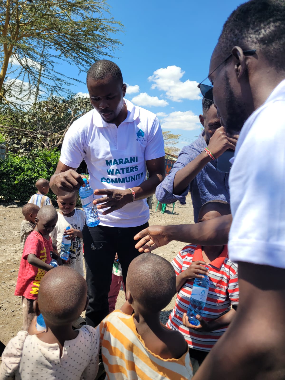 Marani Waters volunteers sharing bottled drinking water with children